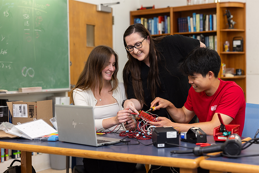 Emily Hawkins teaching physics at LMU to two students